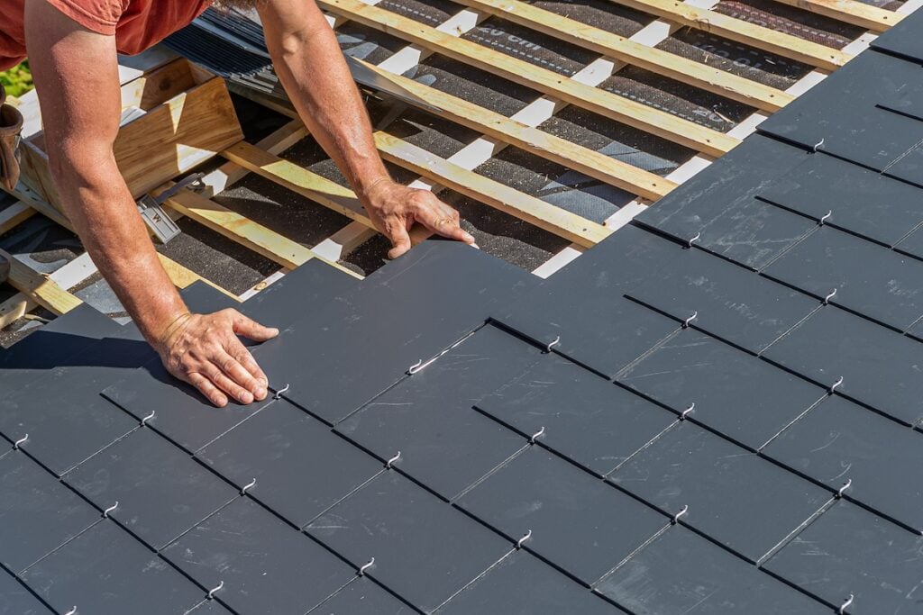 roofer installing a synthetic slate roof