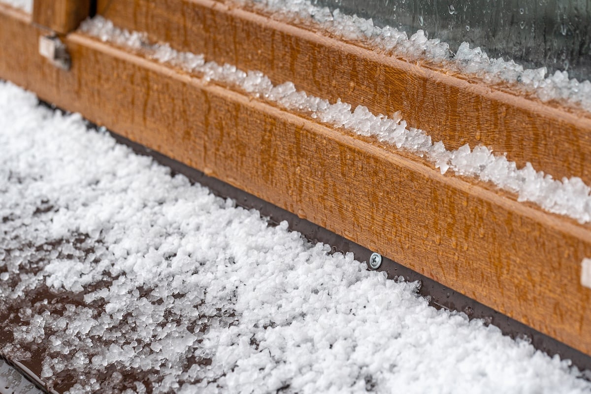 Closeup view photography of white fresh hails particles laying on roof after heavy thunderstorm.